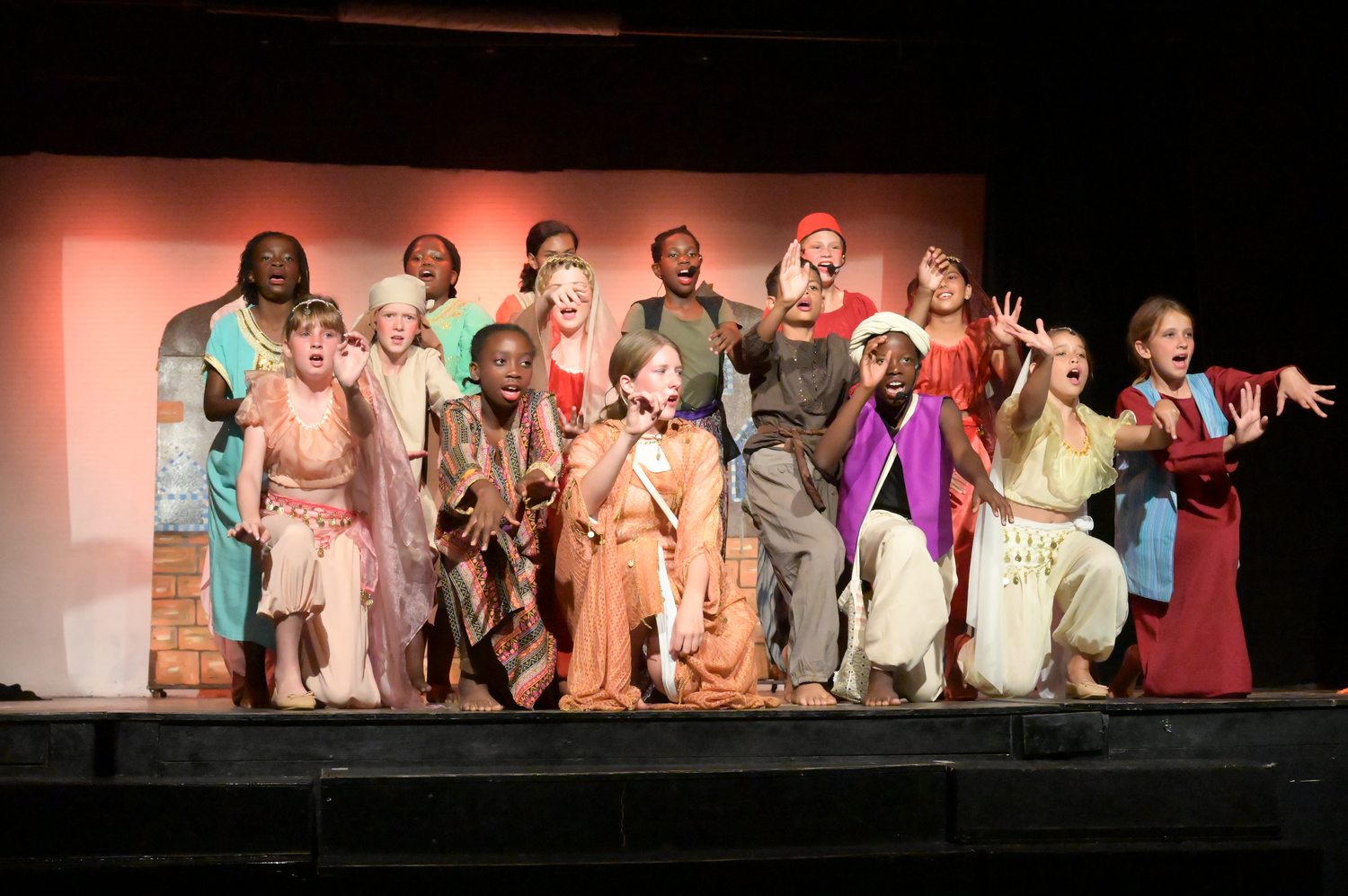 Pupils on stage in costume during a school production